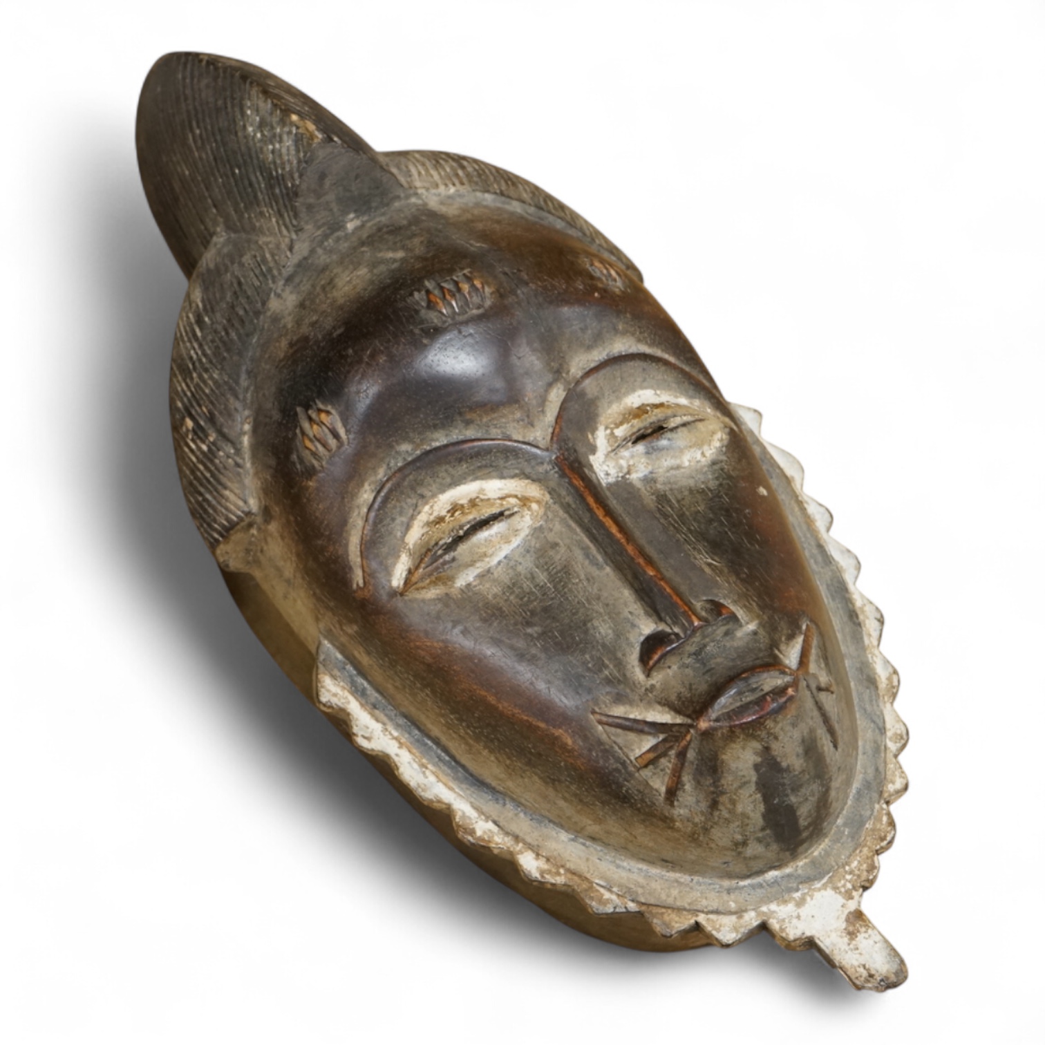 A carved Baule African mask from the Ivory Coast. 38cm high.